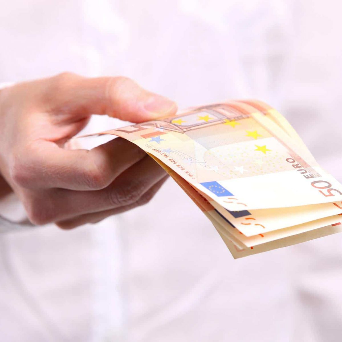 Female hand holding fifty euro banknotes Female hand holding fifty euro banknotes