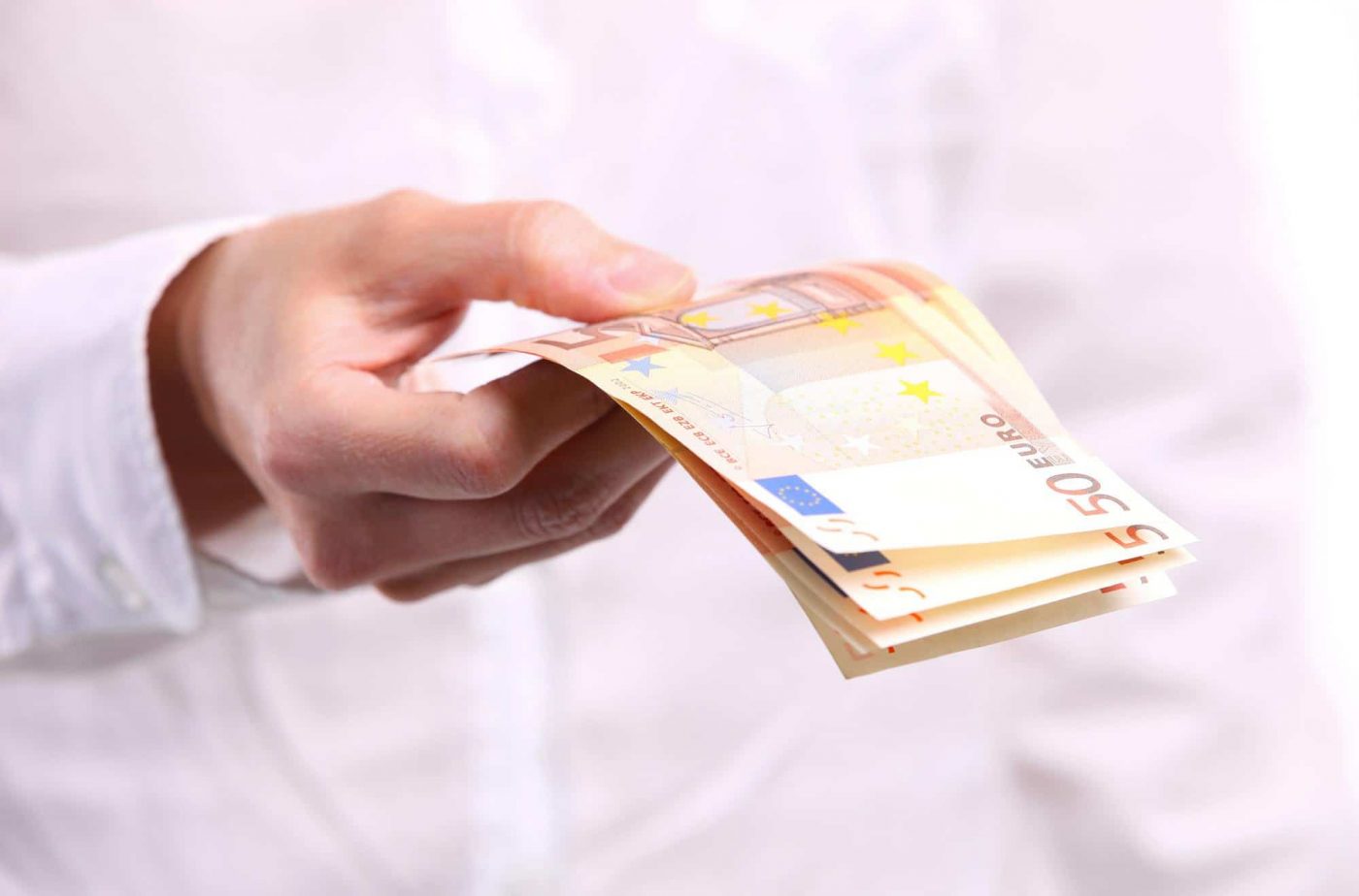 Female hand holding fifty euro banknotes Female hand holding fifty euro banknotes